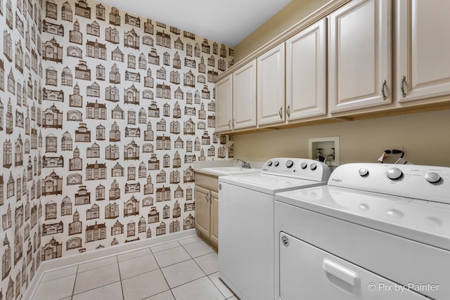 washroom with cabinets, light tile patterned flooring, sink, and washer and clothes dryer