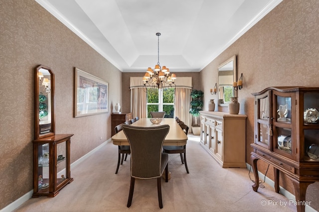 carpeted dining area featuring a tray ceiling and a chandelier