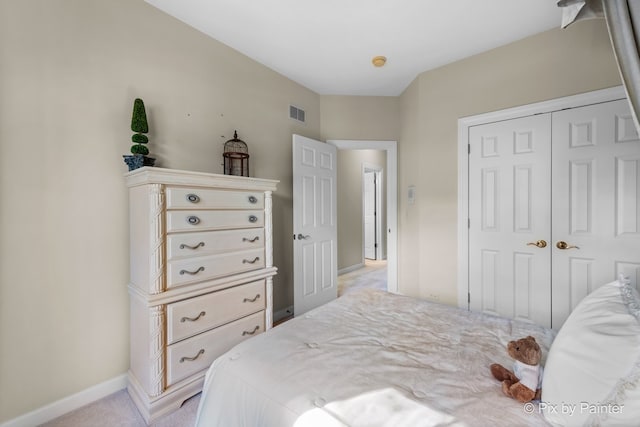 bedroom with light colored carpet and a closet