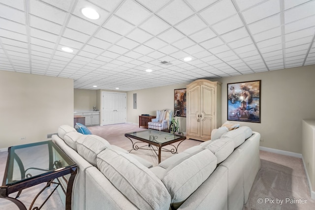 carpeted living room with a paneled ceiling