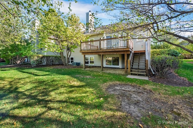 rear view of property with a deck and a lawn