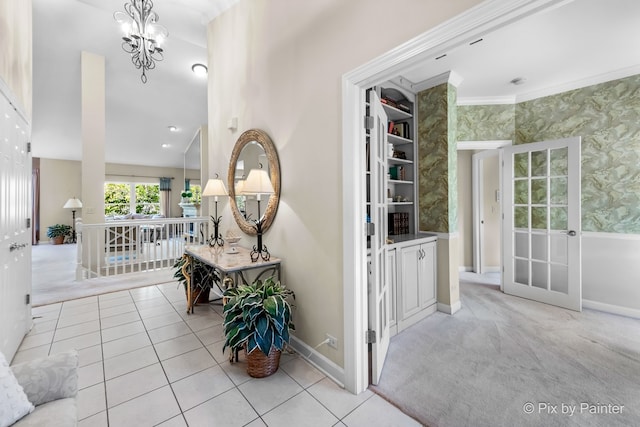 corridor featuring an inviting chandelier, light tile patterned floors, and crown molding