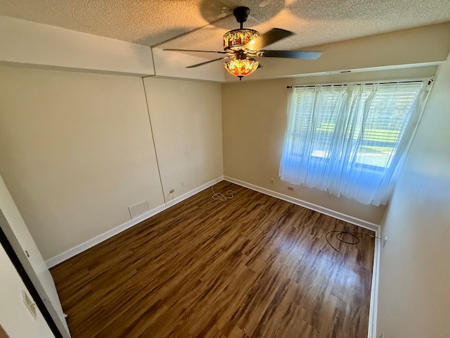 unfurnished room featuring ceiling fan, wood-type flooring, and a textured ceiling