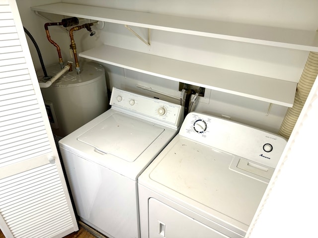 clothes washing area with independent washer and dryer and water heater