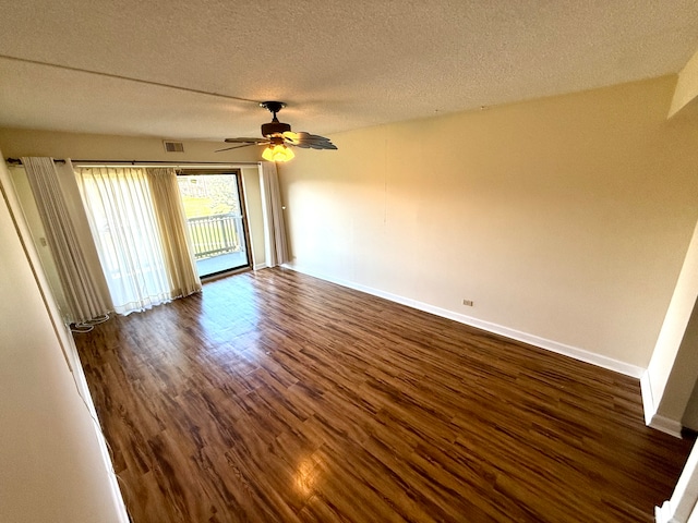 spare room featuring a textured ceiling, ceiling fan, and dark hardwood / wood-style floors