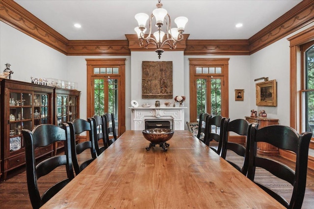 dining room with a chandelier, plenty of natural light, and crown molding