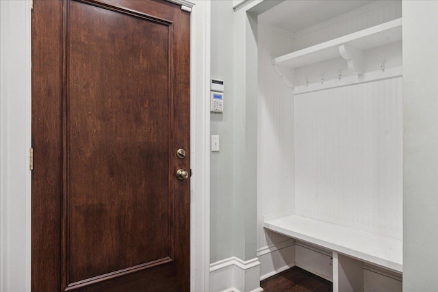 mudroom with built in desk and wood-type flooring