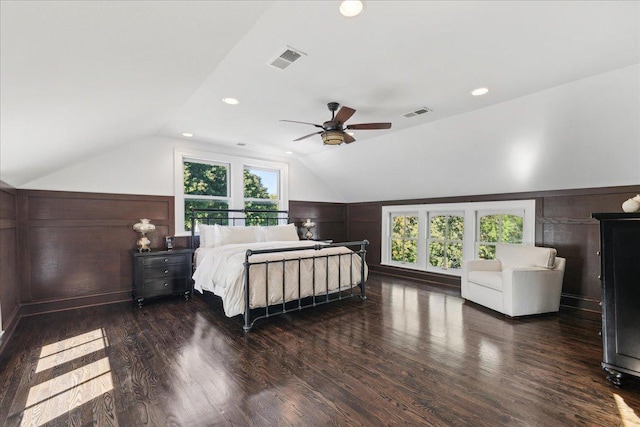 bedroom with dark hardwood / wood-style floors, vaulted ceiling, multiple windows, and ceiling fan