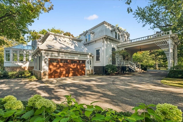 view of front facade featuring covered porch and a garage