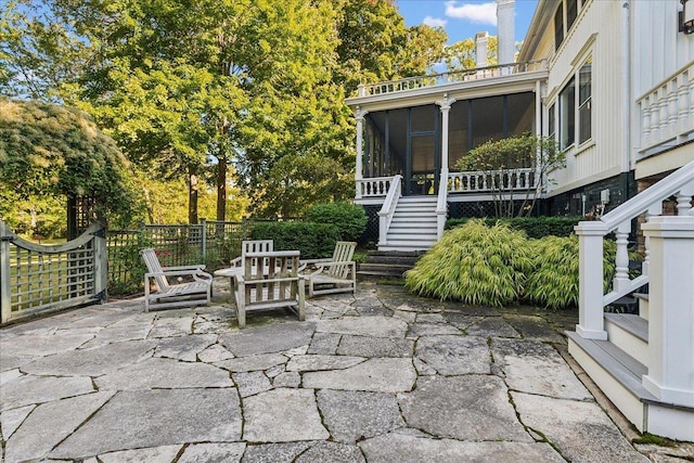 view of patio / terrace featuring a sunroom