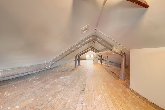 bonus room with hardwood / wood-style flooring and vaulted ceiling