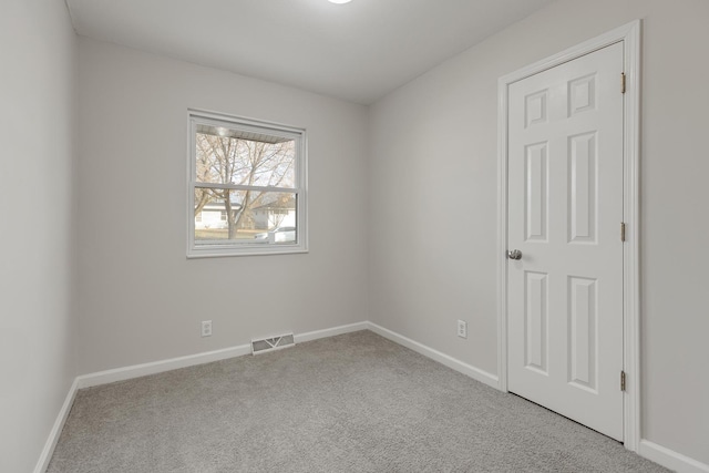 unfurnished room featuring light carpet