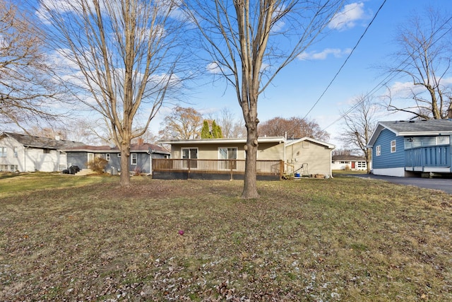 exterior space with a wooden deck and a lawn