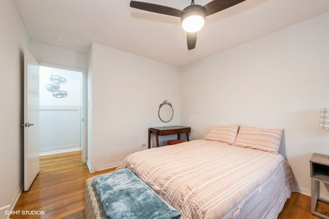 bedroom with hardwood / wood-style flooring and ceiling fan