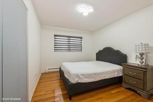 415 S Maple Ave Unit 202, Oak Park, IL 60302 - bedroom with light wood-style floors, baseboard heating, and baseboards