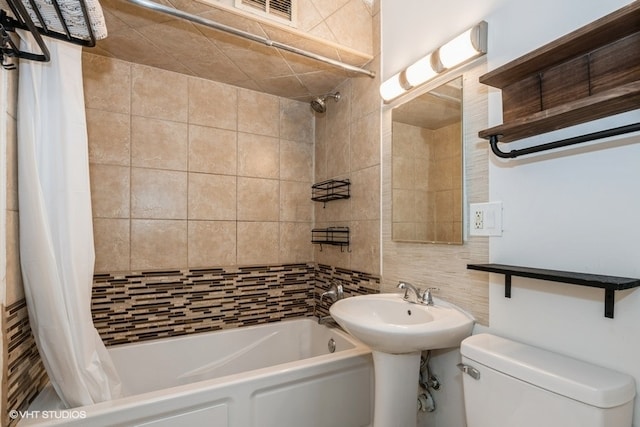 bathroom featuring decorative backsplash, toilet, and shower / bath combo with shower curtain