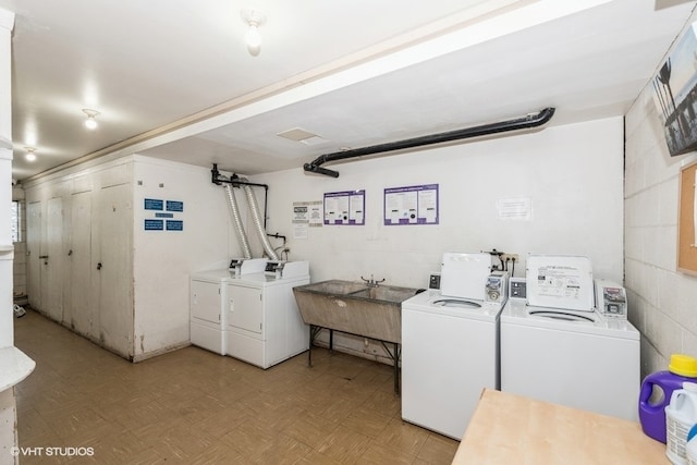 washroom featuring separate washer and dryer, sink, and light parquet floors