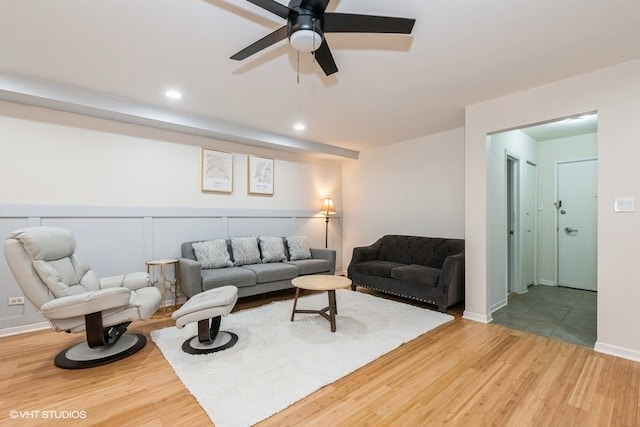 living room featuring hardwood / wood-style floors and ceiling fan