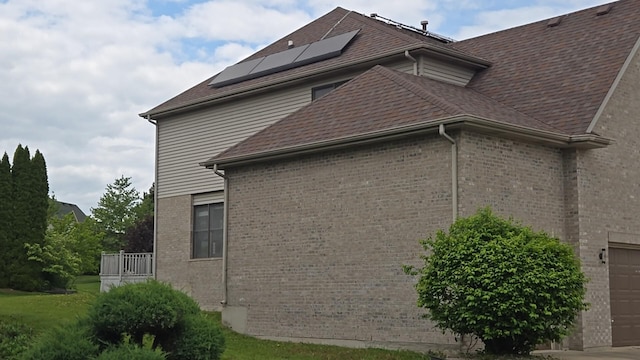 18502 River Rd, Hazel Crest, IL 60429 - view of side of property featuring solar panels, brick siding, and roof with shingles