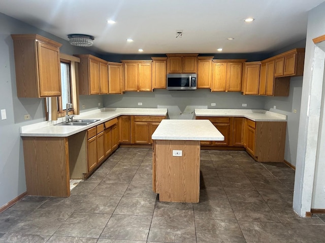 18502 River Rd, Hazel Crest, IL 60429 - kitchen with stainless steel microwave, a sink, baseboards, brown cabinetry, and recessed lighting