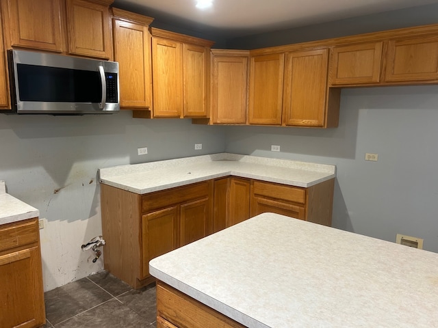 kitchen featuring dark tile patterned floors