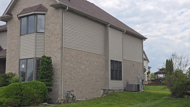 18502 River Rd, Hazel Crest, IL 60429 - view of side of home with brick siding, central air condition unit, and a lawn