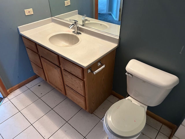 bathroom featuring tile patterned flooring, vanity, and toilet