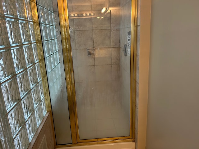 bathroom featuring a shower with door