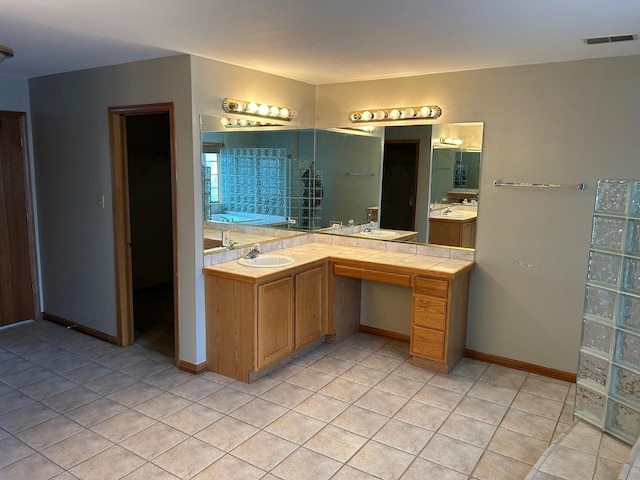 18502 River Rd, Hazel Crest, IL 60429 - full bathroom featuring tile patterned flooring, a garden tub, vanity, and baseboards
