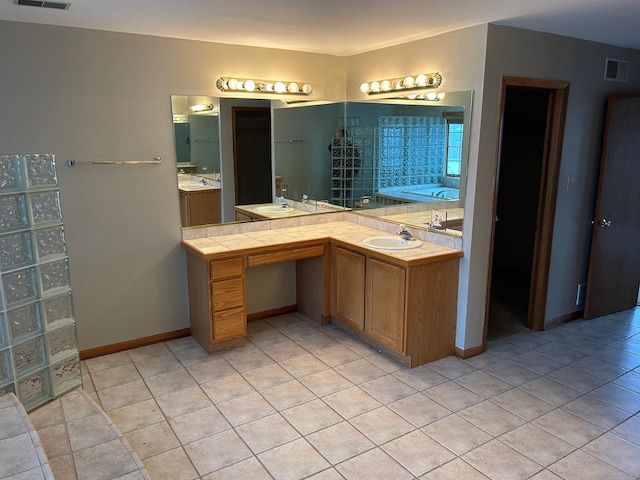 18502 River Rd, Hazel Crest, IL 60429 - bathroom featuring a garden tub, vanity, tile patterned floors, and baseboards