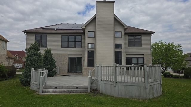 18502 River Rd, Hazel Crest, IL 60429 - rear view of property with a yard, a chimney, roof mounted solar panels, a deck, and roof with shingles