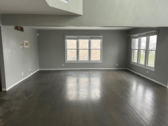 spare room with dark hardwood / wood-style floors