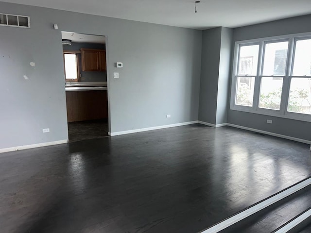 18502 River Rd, Hazel Crest, IL 60429 - empty room with plenty of natural light, baseboards, and dark wood-style floors