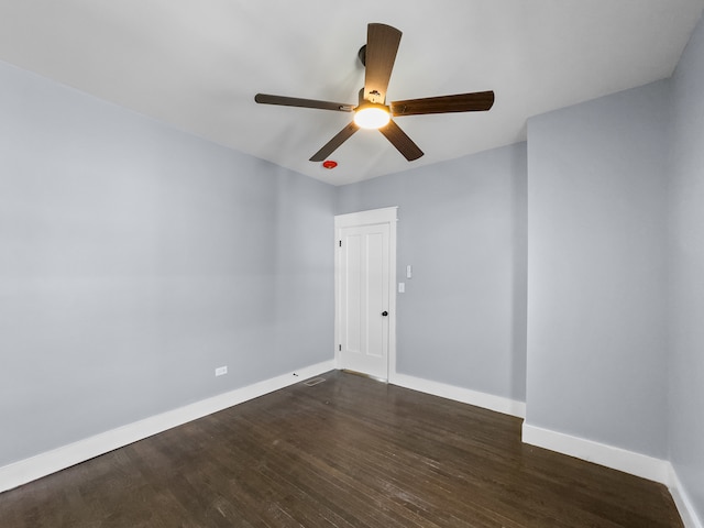 spare room with ceiling fan and dark wood-type flooring