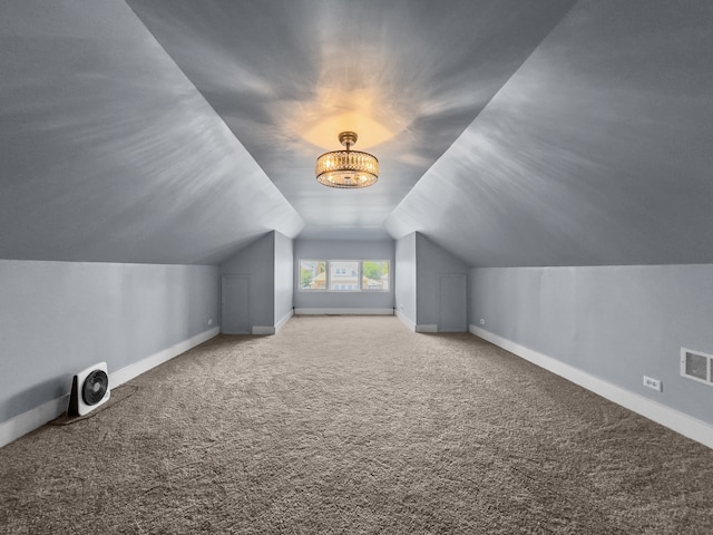 additional living space featuring carpet floors and vaulted ceiling