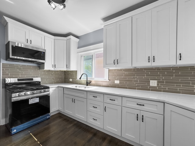 kitchen with white cabinetry, range with gas cooktop, and dark hardwood / wood-style floors