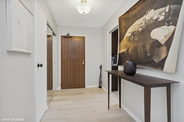 hall with light hardwood / wood-style flooring