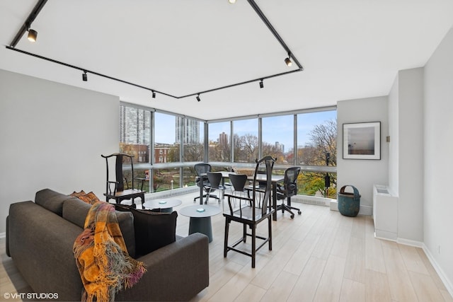 sunroom / solarium featuring plenty of natural light and rail lighting