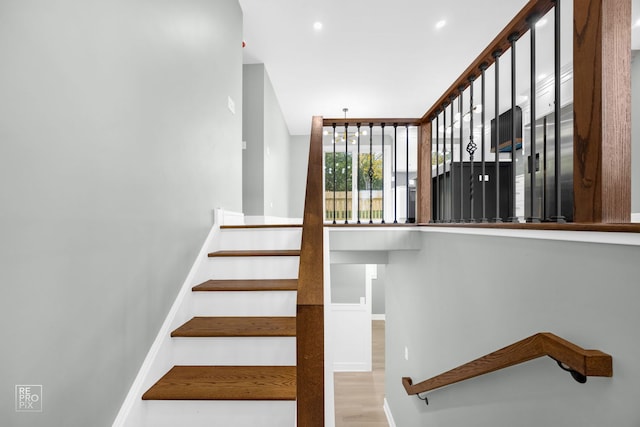 staircase with hardwood / wood-style flooring