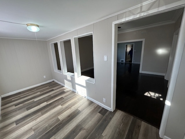 spare room with dark hardwood / wood-style flooring and ornamental molding