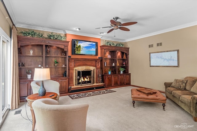 carpeted living room featuring ceiling fan and ornamental molding