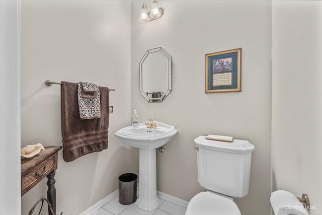 bathroom featuring tile patterned flooring, toilet, and sink