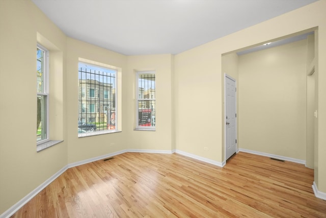 empty room with light hardwood / wood-style floors