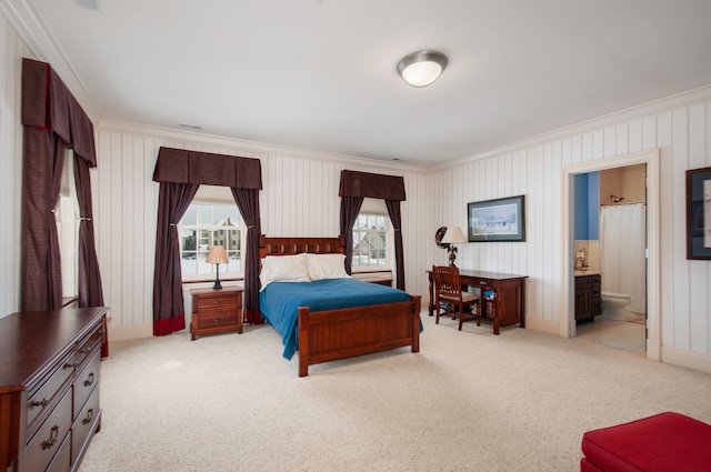 carpeted bedroom with connected bathroom, multiple windows, and ornamental molding