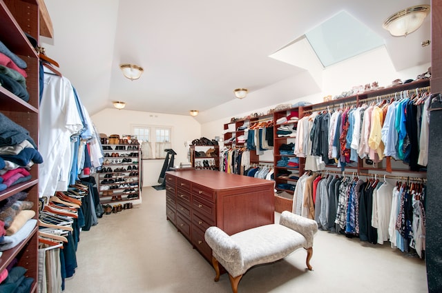 walk in closet featuring light carpet and vaulted ceiling