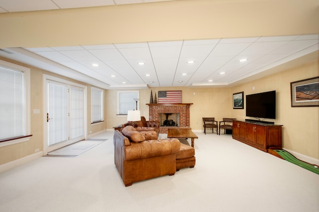 living room with a fireplace and light colored carpet