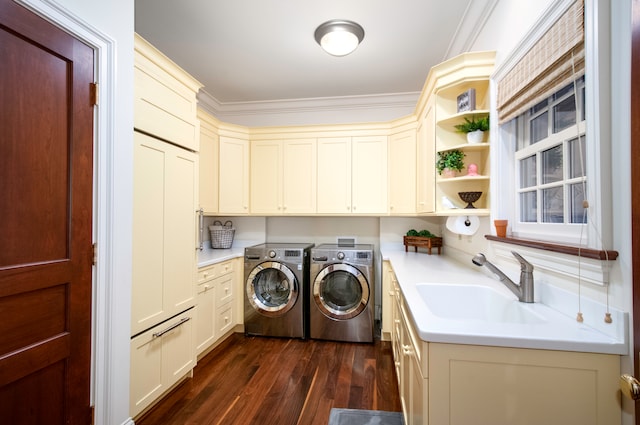 laundry room with cabinets, sink, washer and dryer, dark hardwood / wood-style floors, and ornamental molding