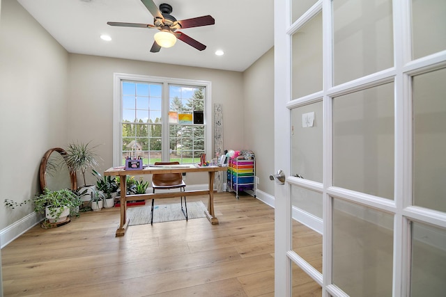 home office featuring light hardwood / wood-style floors, french doors, and ceiling fan