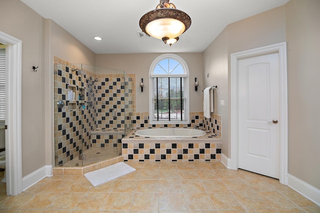 bathroom with tile patterned flooring and independent shower and bath