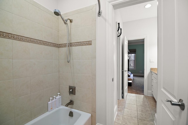 bathroom featuring tiled shower / bath combo, vanity, and tile patterned floors